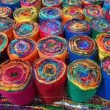 Recycled Sari Silk Ribbon rolls is the by-product of colorful saris that women wear in India. It is the loose ends of saris collected from industrial mills in India that is torn in stripes and sewn end to end to make beautiful and colorful ribbons. The vibrant colors and unique texture of these silk fabric, the sari silk ribbons-Rolls are inspirational to designers, knitters, and artisans.
