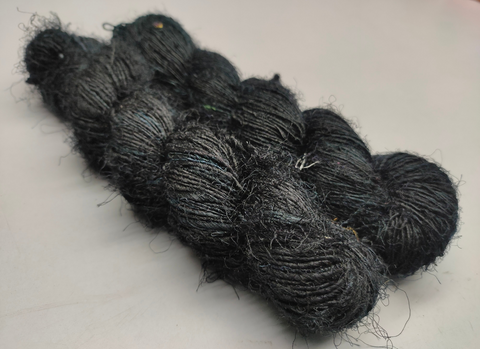 Recycled Sari Silk Yarn Prime - Black is available in multitude of colors, and being premium, you get extra length of yarn in the same weight. We fabricate Himalaya Silk Yarn from the bi-product of sari and silk production units. The Yarn, available with us, is hand spun into bright hanks which is suitable for number of Handicrafts applications. Himalaya Sil