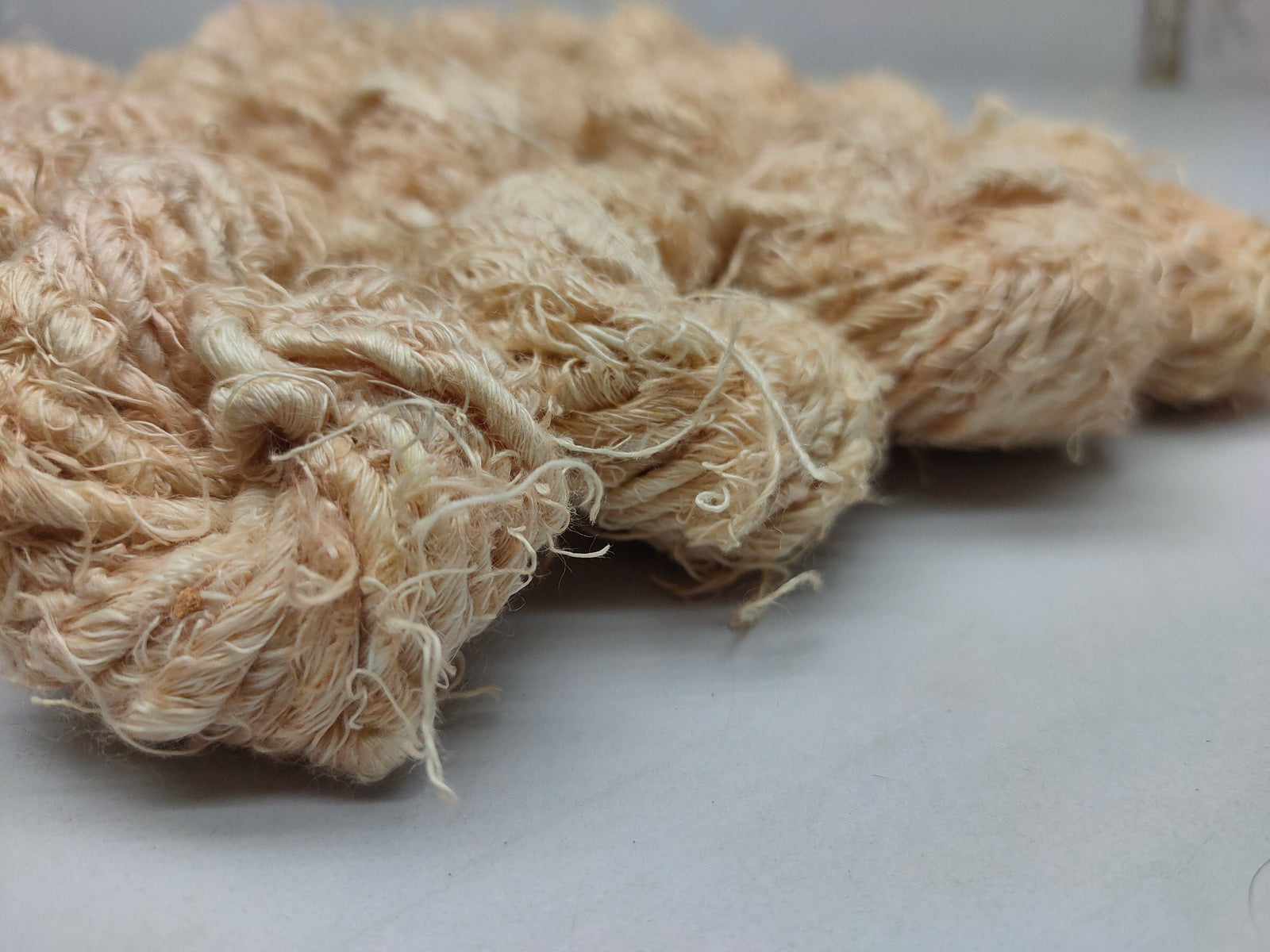 Recycled Linen Yarn Beigi is made from leftover or excessive warp/ weft thread on handlooms / powerloom, to be specific the byproduct linen from industrial Linen weaving unit in India. The yarn is hand-spun, using drop spindle helping women cooperatives to earn their livelihood.
