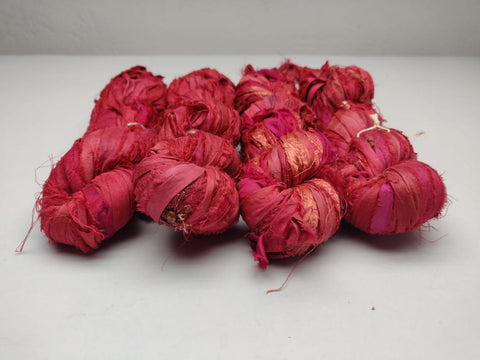Recycled Sari Silk Ribbon-Brick is the by-product of colorful saris that women wear in India. It is the loose ends of saris collected from industrial mills in India that is torn in stripes and sewn end to end to make beautiful and colorful ribbons. The vibrant colors and unique texture of these silk fabric, the sari silk ribbons are inspirational to designers, knitters, and artisans.