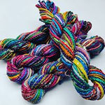 Cording Sari Silk Ribbon - Multicolor - SilkRouteIndiaFair Trade Recycled Lurex Hemmed Cording Sari Silk Ribbon yarn. Very sparkling! Made from Recycled Sari silk Ribbon which is the by-product of colorful saris that women wear in India. It is the loose ends of saris collected from industrial mills in India that is torn in stripes and sewn end to end to make beautiful and colorful ribbons. The vibrant colors and unique texture of these silk fabric, the s