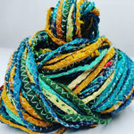 Cording Sari Silk Ribbon - Multicolor - SilkRouteIndiaFair Trade Recycled Lurex Hemmed Cording Sari Silk Ribbon yarn. Very sparkling! Made from Recycled Sari silk Ribbon which is the by-product of colorful saris that women wear in India. It is the loose ends of saris collected from industrial mills in India that is torn in stripes and sewn end to end to make beautiful and colorful ribbons. The vibrant colors and unique texture of these silk fabric, the s