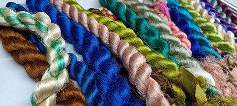 Sari Silk Fiber - Jewels Tone is available in assorted colorways, and is braided! They are the strongest natural roving fibers and are spun into a wonderful yarn used for knitting and weaving! The Colorful Sari Silk Thrums have a lovely draping quality. The fiber is a smooth filament and the fabric out of it is comfortable against the skin. Silk is a natural protein fiber. These roving fibers are well known for its shine, lustre and tensile strength.