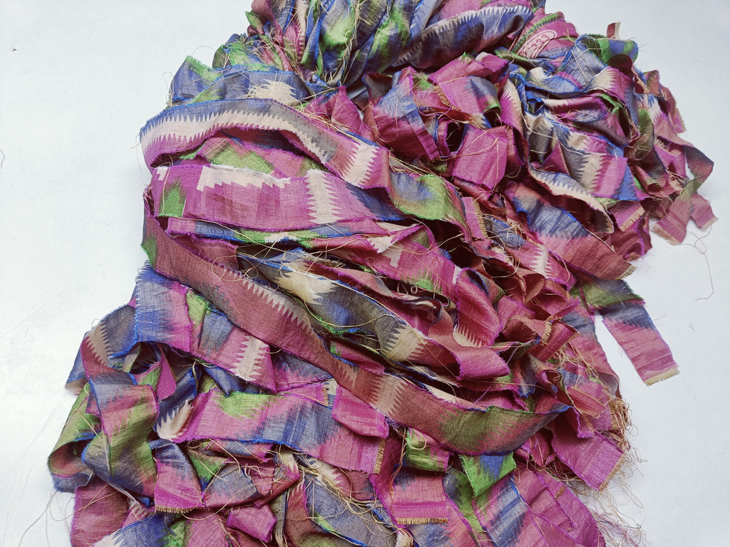 Reclaimed Indian Sari Stripe is the by-product of colorful saris that women wear in India. It is the loose ends of saris collected from industrial mills in India that is torn in stripes to make beautiful and colorful stripes. The vibrant colors and unique texture of these sari stripe, the sari Stripe are inspirational to designers, knitters, and artisans. The popularity of Sari Stripe has extended beyond India and has created an empowering cottage industry primarily benefiting women.