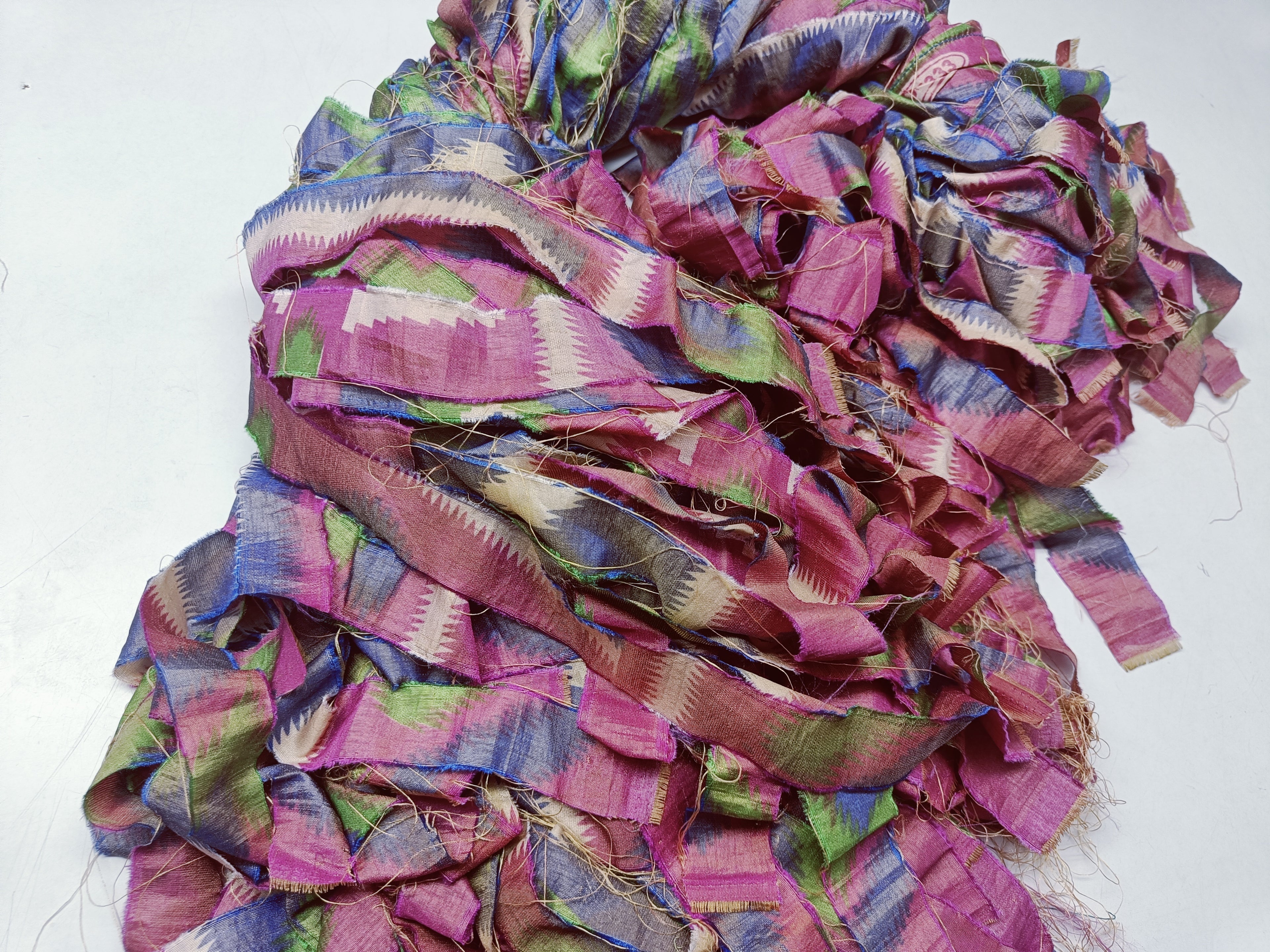 Reclaimed Indian Sari Stripe is the by-product of colorful saris that women wear in India. It is the loose ends of saris collected from industrial mills in India that is torn in stripes to make beautiful and colorful stripes. The vibrant colors and unique texture of these sari stripe, the sari Stripe are inspirational to designers, knitters, and artisans. The popularity of Sari Stripe has extended beyond India and has created an empowering cottage industry primarily benefiting women.