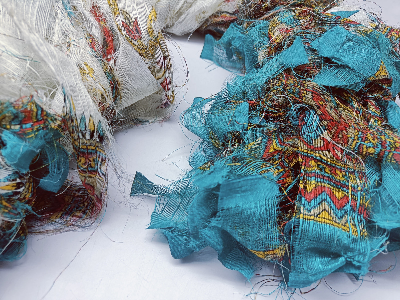 Reclaimed Indian Sari Stripe is the by-product of colorful saris that women wear in India. It is the loose ends of saris collected from industrial mills in India that is torn in stripes to make beautiful and colorful stripes. The vibrant colors and unique texture of these sari stripe, the sari Stripe are inspirational to designers, knitters, and artisans. The popularity of Sari Stripe has extended beyond India and has created an empowering cottage industry primarily benefiting women.