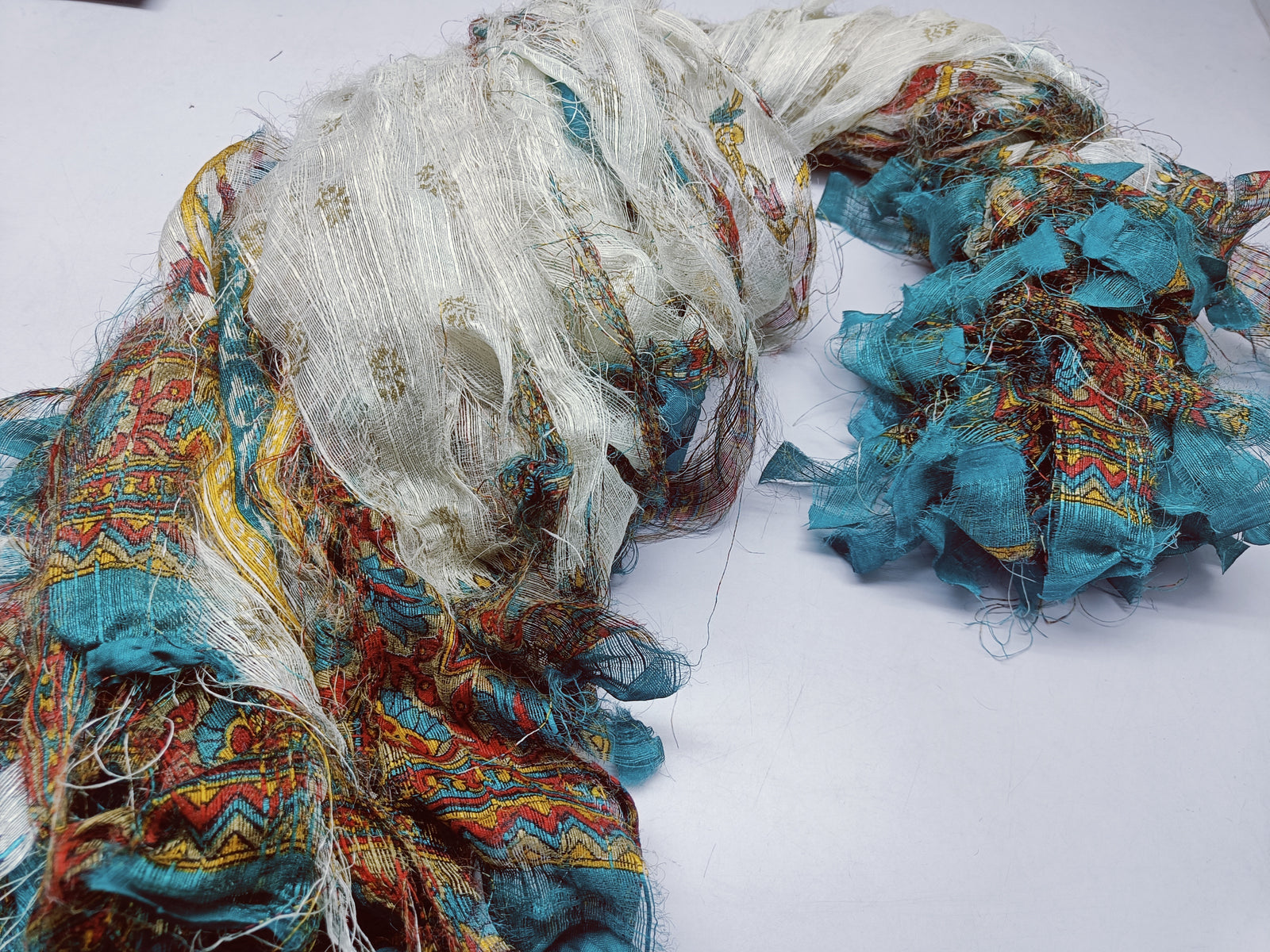 Reclaimed Indian Sari Stripe is the by-product of colorful saris that women wear in India. It is the loose ends of saris collected from industrial mills in India that is torn in stripes to make beautiful and colorful stripes. The vibrant colors and unique texture of these sari stripe, the sari Stripe are inspirational to designers, knitters, and artisans. The popularity of Sari Stripe has extended beyond India and has created an empowering cottage industry primarily benefiting women.