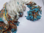 Reclaimed Indian Sari Stripe is the by-product of colorful saris that women wear in India. It is the loose ends of saris collected from industrial mills in India that is torn in stripes to make beautiful and colorful stripes. The vibrant colors and unique texture of these sari stripe, the sari Stripe are inspirational to designers, knitters, and artisans. The popularity of Sari Stripe has extended beyond India and has created an empowering cottage industry primarily benefiting women.