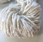 Banana Yarn-Off White has a similar appearance as Recycled Yarn, the difference being the viscose rayon fiber content in Banana Yarns. We manufacture Banana Yarn using state of the art facility. The manufacturing process includes refining, processing and spinning by Women cooperatives using the drop spindle.