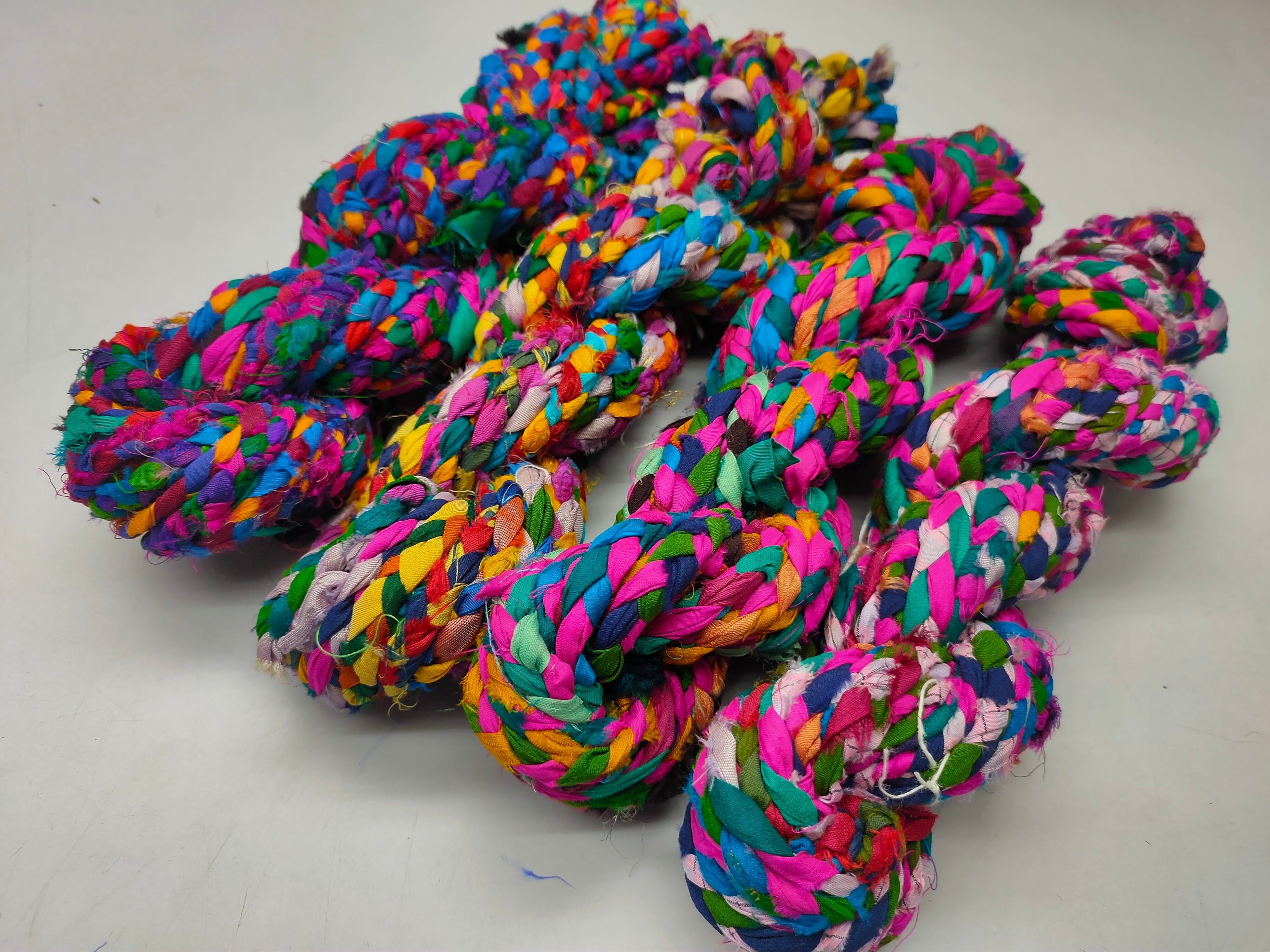 Braided yarn is made of pure silk and is approximately an inch wide through out. Due to its handmade nature there might occasionally be variations in width. When silk fabric is cut and made into saris, wraps, and veils, there is always a bit left over. Rather than throw that waste fiber into the trash, it has been made into a beautiful, unique, soft yarn..!! Direct from India, this yarn is a truly recycled product. It is a bulky weight and is soft and easy to knit or crochet.