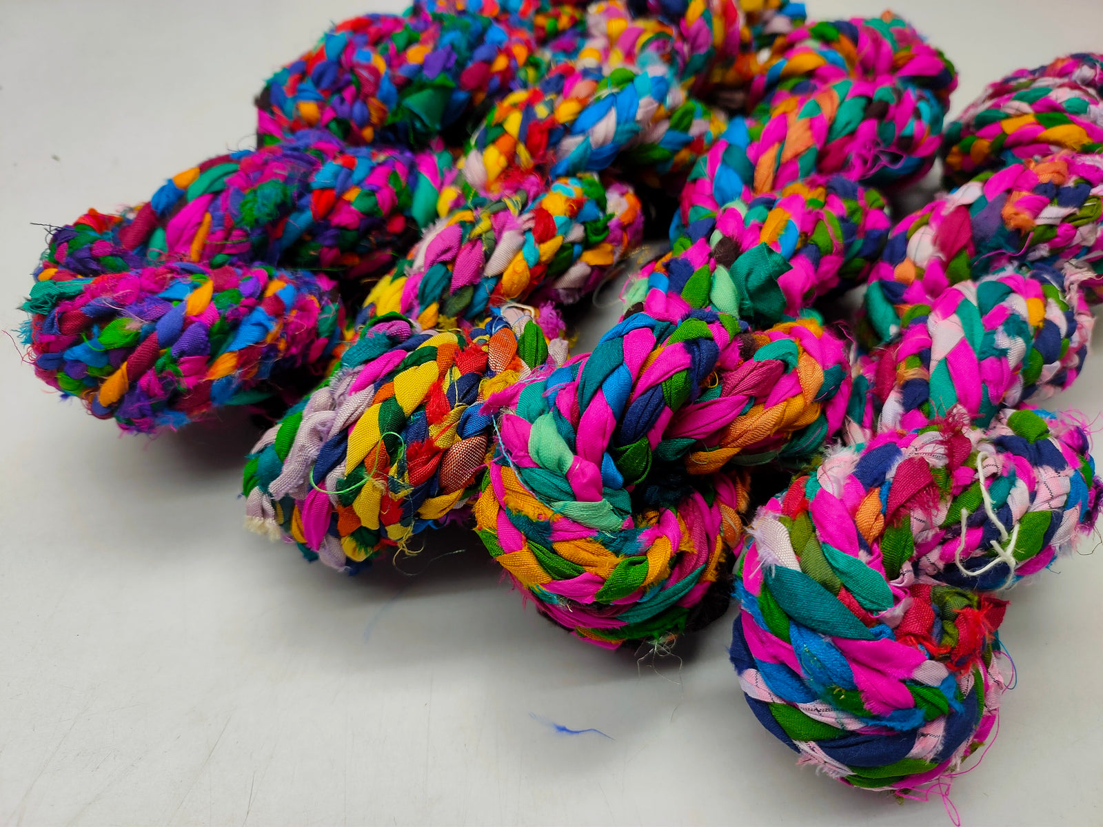 yarn is made of pure silk and is approximately an inch wide through out. Due to its handmade nature there might occasionally be variations in width. When silk fabric is cut and made into saris, wraps, and veils, there is always a bit left over. Rather than throw that waste fiber into the trash, it has been made into a beautiful, unique, soft yarn..!! Direct from India, this yarn is a truly recycled product. It is a bulky weight and is soft and easy to knit or crochet.