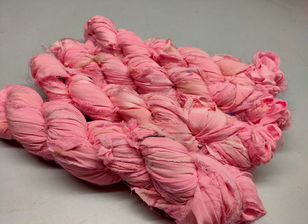 Chiffon Ribbon Yarn is the by-product of saris that women wear in India. It is the loose ends of saris collected from industrial mills in India that is torn in stripes and sewn end to end to make beautiful and colorful ribbons. The vibrant colors and unique texture of these silk fabric, the Chiffon Silk Ribbon are inspirational to designers, knitters, and artisans. 