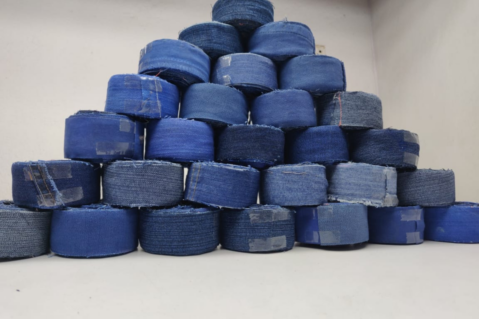 Recycled Denim Ribbon/ Denim Cotton Ribbon is the by-product of jeans wear in India. Are you planning to buy Denim Ribbon Online? The jeans are washed and then torn in stripes and sewn end to end to make beautiful.