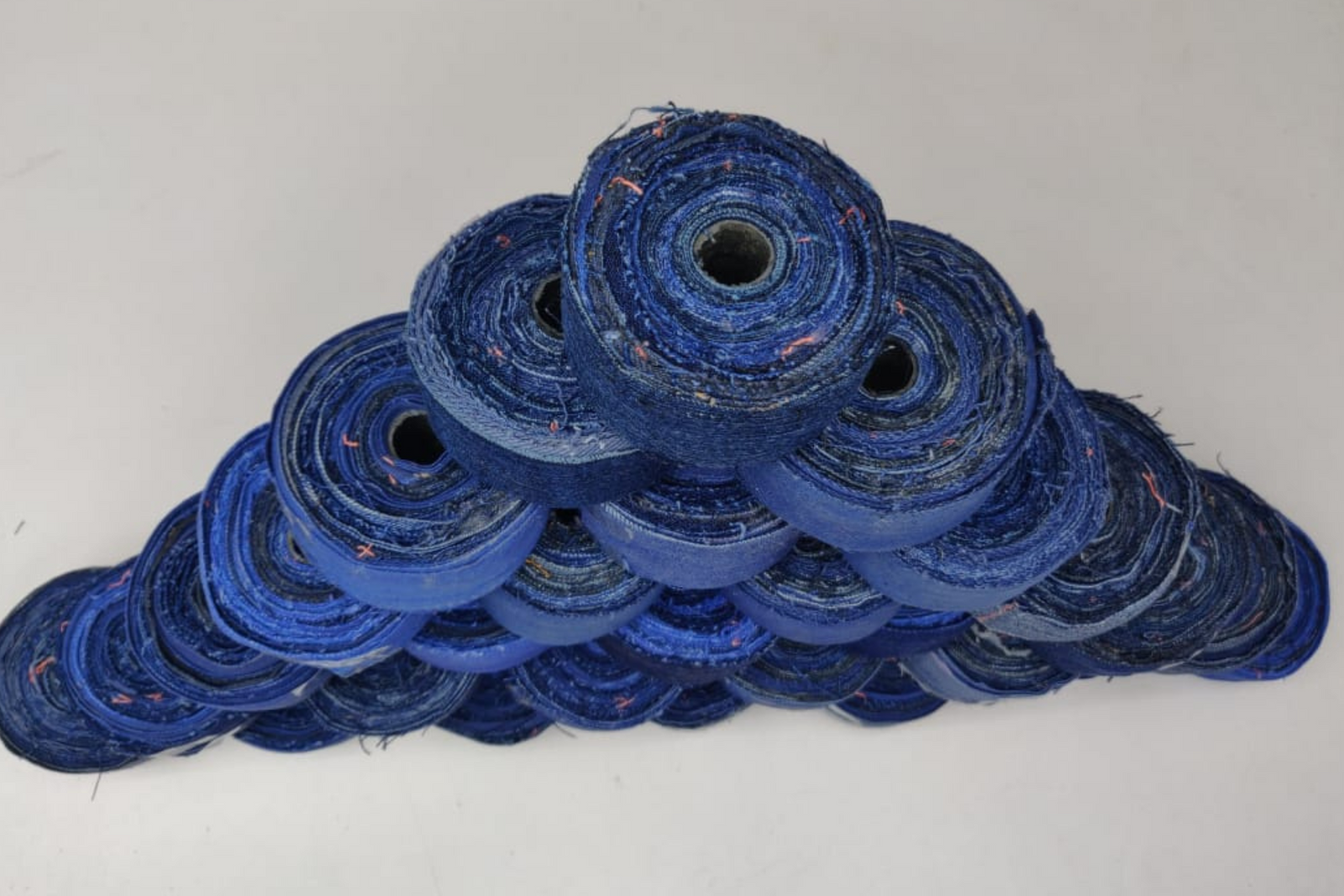Recycled Denim Ribbon/ Denim Cotton Ribbon is the by-product of jeans wear in India. Are you planning to buy Denim Ribbon Online? The jeans are washed and then torn in stripes and sewn end to end to make beautiful.