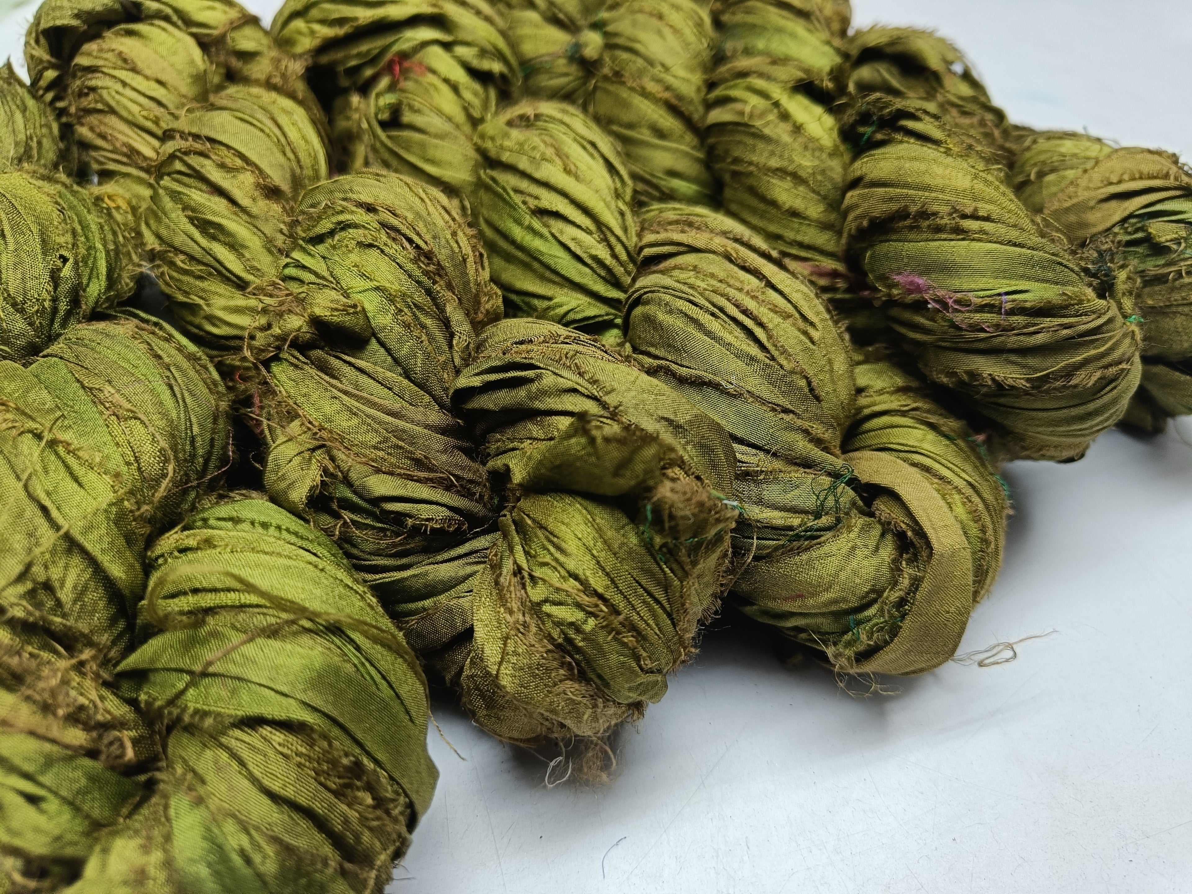 Recycled Sari silk Ribbon is the by-product of colorful saris that women wear in India. It is the loose ends of saris collected from industrial mills in India that is torn in stripes and sewn end to end to make beautiful and colorful ribbons. 