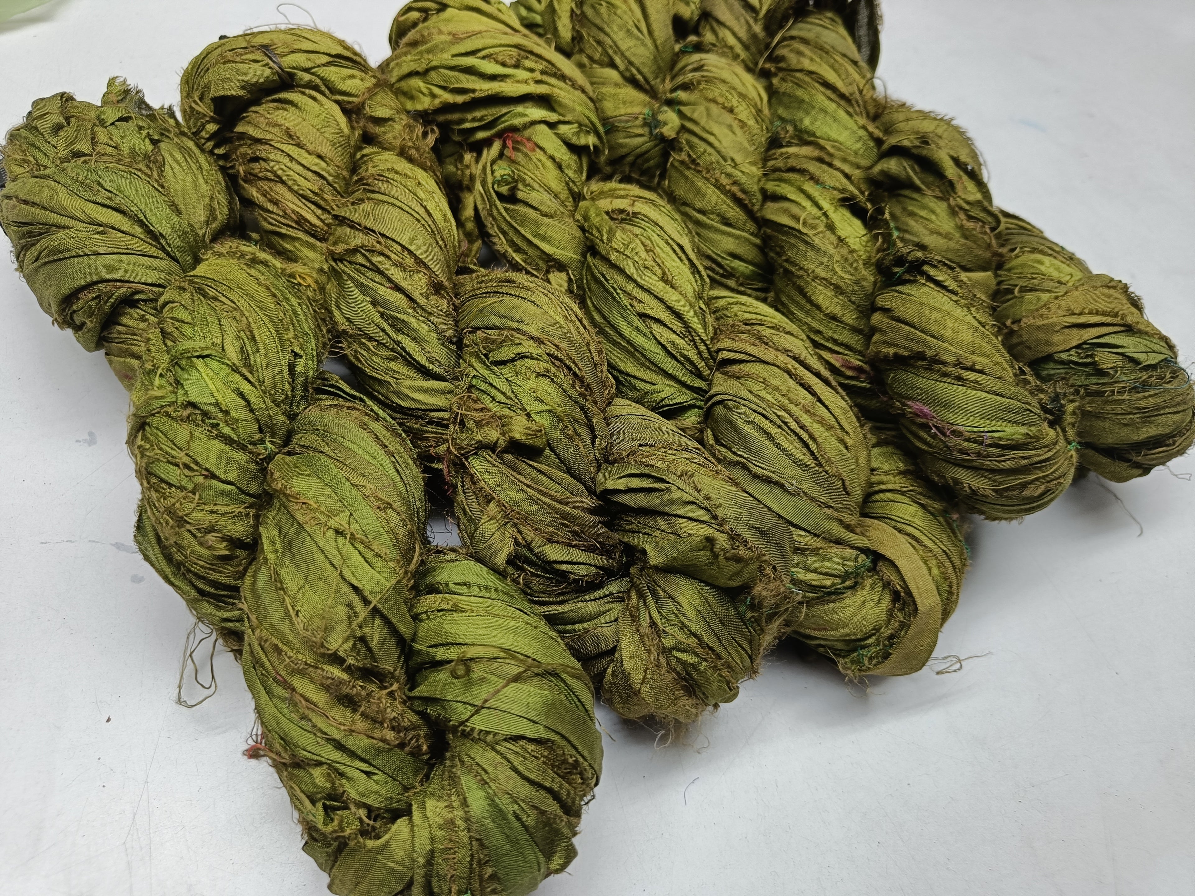 Recycled Sari silk Ribbon is the by-product of colorful saris that women wear in India. It is the loose ends of saris collected from industrial mills in India that is torn in stripes and sewn end to end to make beautiful and colorful ribbons. 