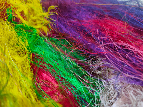 Recycled Sari Silk Fibers is available in assorted colorways, and is open status. They are the strongest natural fibers and are spun into a wonderful yarn used for knitting and weaving! The Silk fabrics have a lovely draping quality.