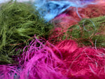 Recycled Sari Silk Fibers is available in assorted colorways, and is open status. They are the strongest natural fibers and are spun into a wonderful yarn used for knitting and weaving! The Silk fabrics have a lovely draping quality.
