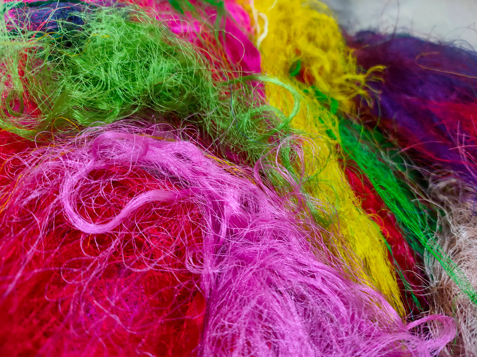 Recycled Sari Silk Fibers is available in assorted colorways, and is open status. They are the strongest natural fibers and are spun into a wonderful yarn used for knitting and weaving! The Silk fabrics have a lovely draping quality.