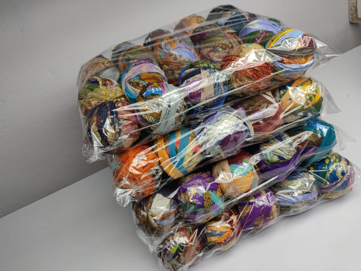 Recycled Sari silk Ribbon-Rolls is the by-product of colorful saris that women wear in India. It is the loose ends of saris collected from industrial mills in India that is torn in stripes and sewn end to end to make beautiful and col