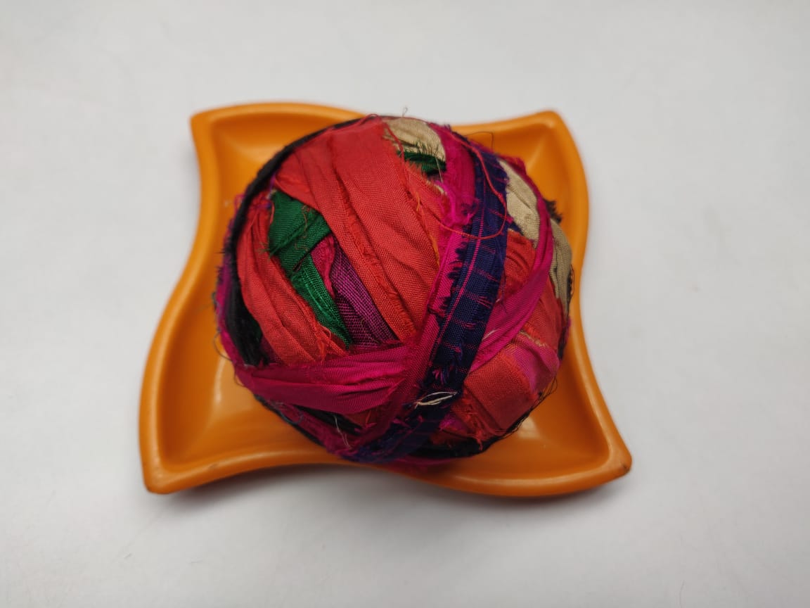 Recycled Sari silk Ribbon-Rolls is the by-product of colorful saris that women wear in India. It is the loose ends of saris collected from industrial mills in India that is torn in stripes and sewn end to end to make beautiful and col