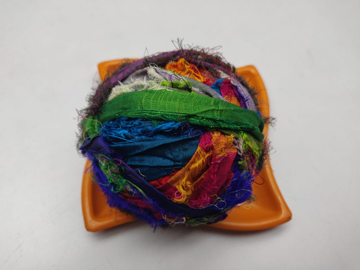 Recycled Sari silk Ribbon-Rolls is the by-product of colorful saris that women wear in India. It is the loose ends of saris collected from industrial mills in India that is torn in stripes and sewn end to end to make beautiful and col