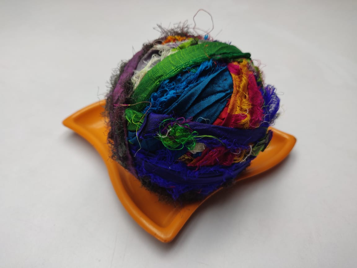 Recycled Sari silk Ribbon-Rolls is the by-product of colorful saris that women wear in India. It is the loose ends of saris collected from industrial mills in India that is torn in stripes and sewn end to end to make beautiful and col