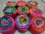 Recycled Sari Silk Ribbon rolls is the by-product of colorful saris that women wear in India. It is the loose ends of saris collected from industrial mills in India that is torn in stripes and sewn end to end to make beautiful and colorful ribbons. The vibrant colors and unique texture of these silk fabric, the sari silk ribbons-Rolls are inspirational to designers, knitters, and artisans.