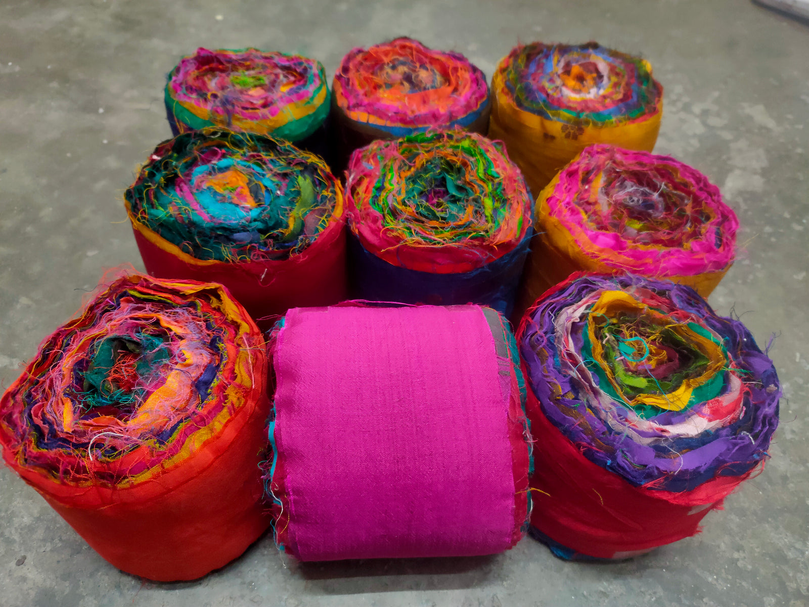 Recycled Sari Silk Ribbon rolls is the by-product of colorful saris that women wear in India. It is the loose ends of saris collected from industrial mills in India that is torn in stripes and sewn end to end to make beautiful and colorful ribbons. The vibrant colors and unique texture of these silk fabric, the sari silk ribbons-Rolls are inspirational to designers, knitters, and artisans.