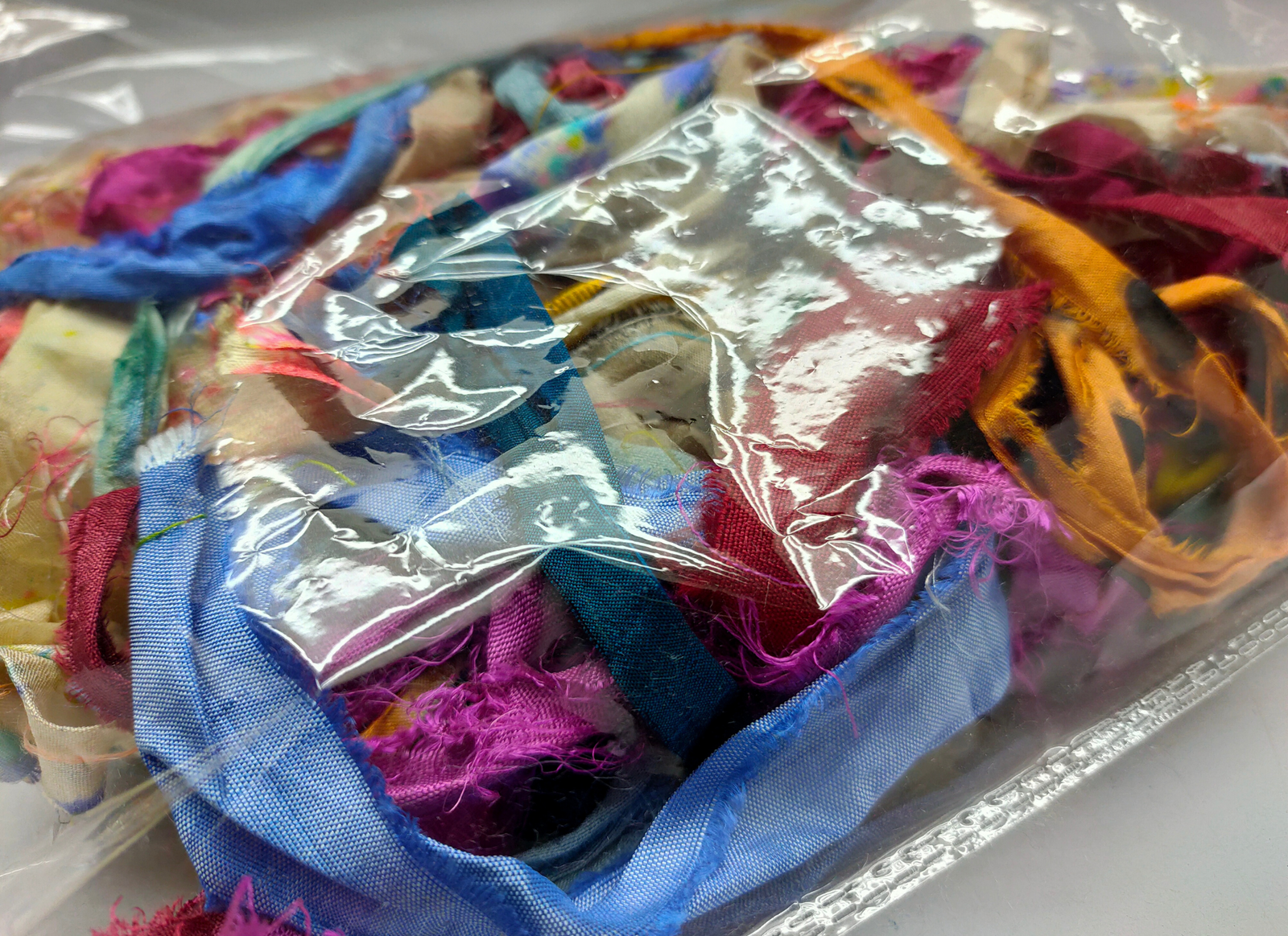 This ribbons scraps is made of completely recycled Sari material from recycled clothing. We work with women’s Cooperative in the countryside to produce this unique ribbons and other hand knitted silk yarn products. Women make this ribbons and various knitwear in their homes while not neglecting their other household chores. This work provides additional income to support and improve their family earnings.