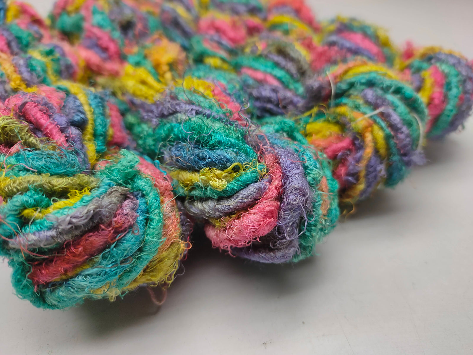 Recycle Sari Silk Yarn are the remnants of traditionally crafted Indian Saris and are extensively used in making hats, mittens, hued scarves, etc. We offer Recycle Sari Silk Yarn comprising of 100% and they are not over spun unlike some natural yarn. Each skein has distinct color, gauge, twist and texture. Varying in weight, our Recycled Sari Yarn are hailed for their quality and strength.