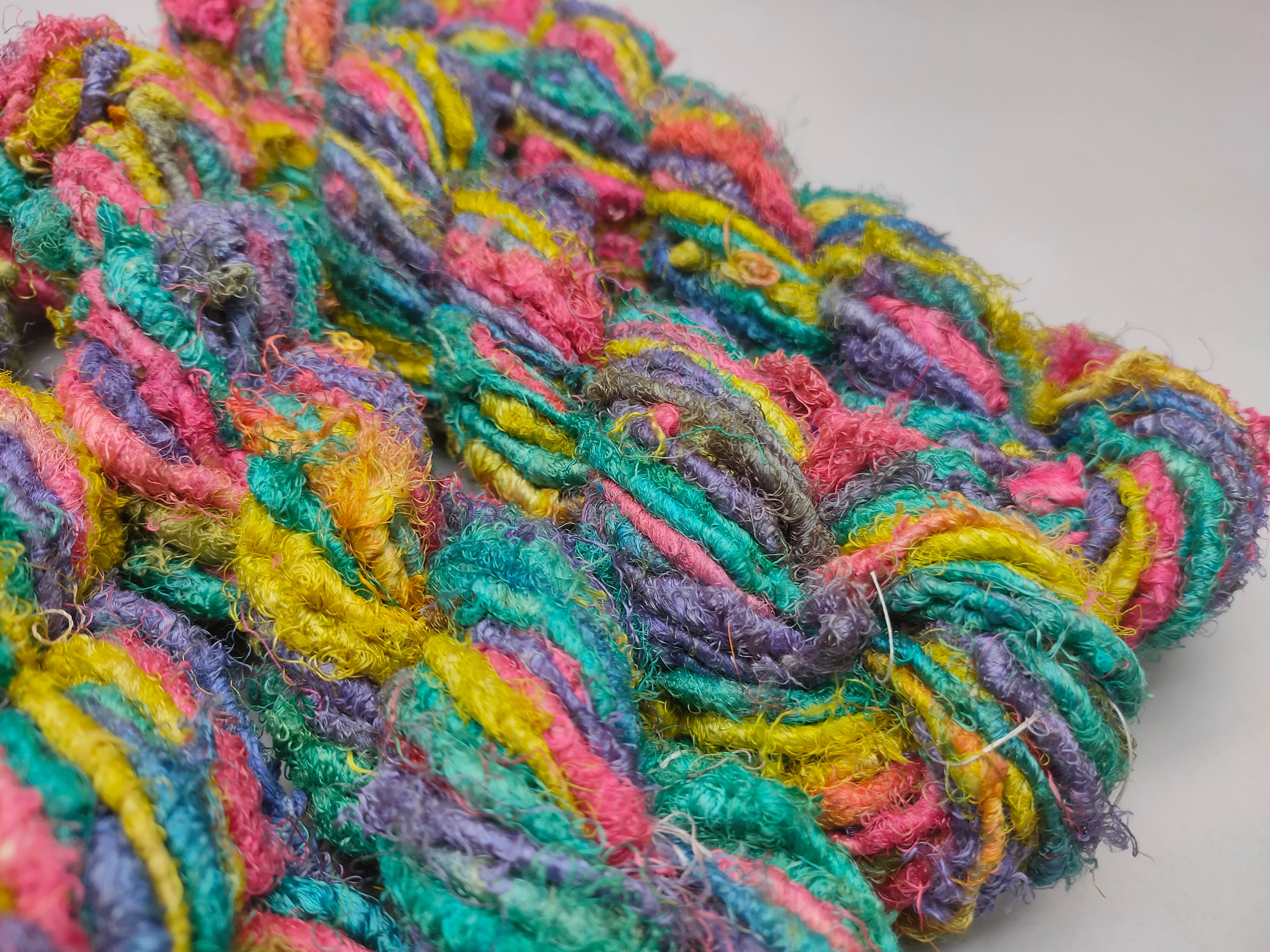 Recycle Sari Silk Yarn are the remnants of traditionally crafted Indian Saris and are extensively used in making hats, mittens, hued scarves, etc. We offer Recycle Sari Silk Yarn comprising of 100% and they are not over spun unlike some natural yarn. Each skein has distinct color, gauge, twist and texture. Varying in weight, our Recycled Sari Yarn are hailed for their quality and strength.