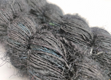 Recycled Sari Silk Yarn Prime - Black is available in multitude of colors, and being premium, you get extra length of yarn in the same weight. We fabricate Himalaya Silk Yarn from the bi-product of sari and silk production units. The Yarn, available with us, is hand spun into bright hanks which is suitable for number of Handicrafts applications.