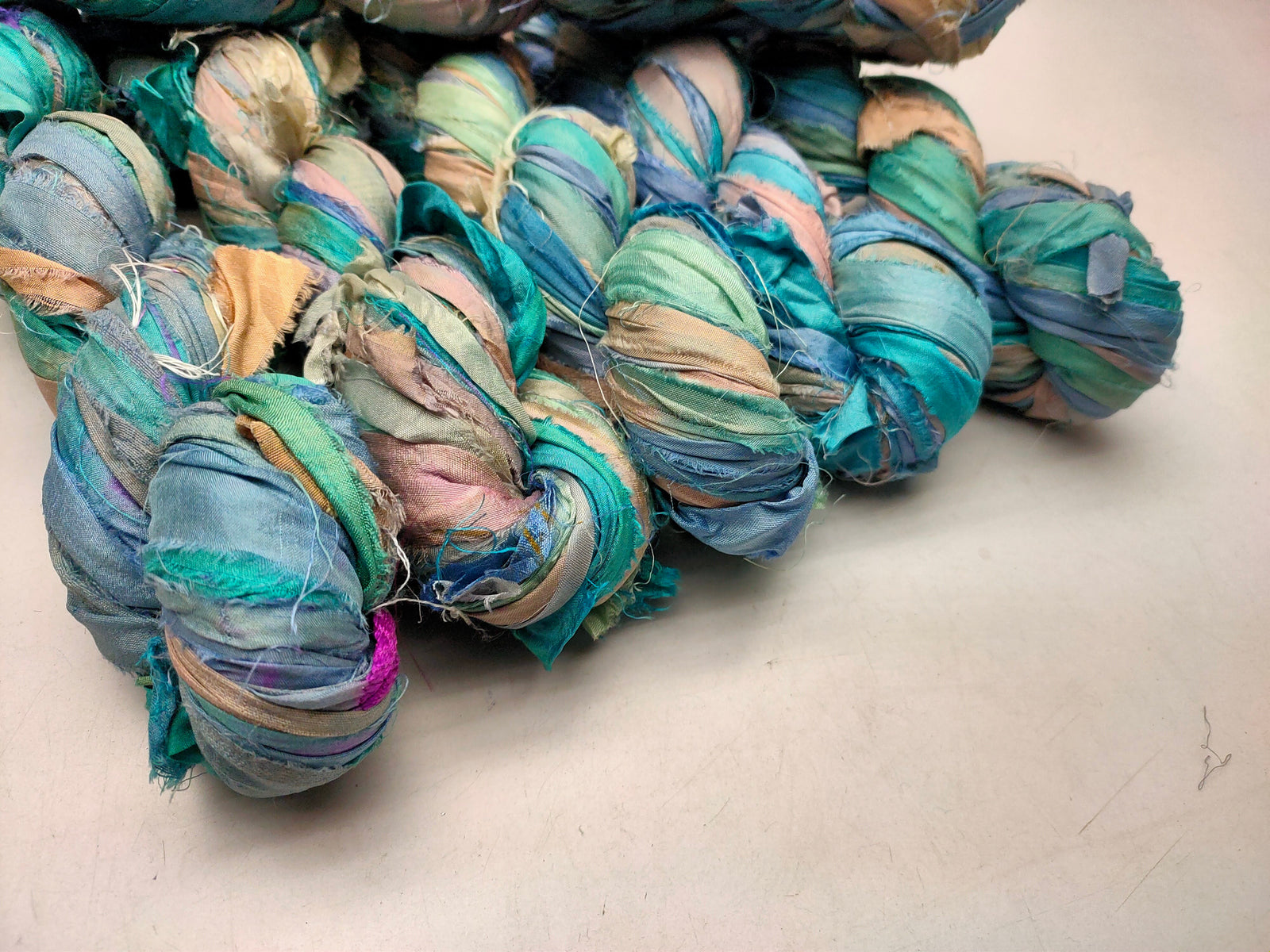 Recycled Sari silk Ribbon is the by-product of colorful saris that women wear in India. It is the loose ends of saris collected from industrial mills in India that is torn in stripes and sewn end to end to make beautiful and colorful ribbons. 