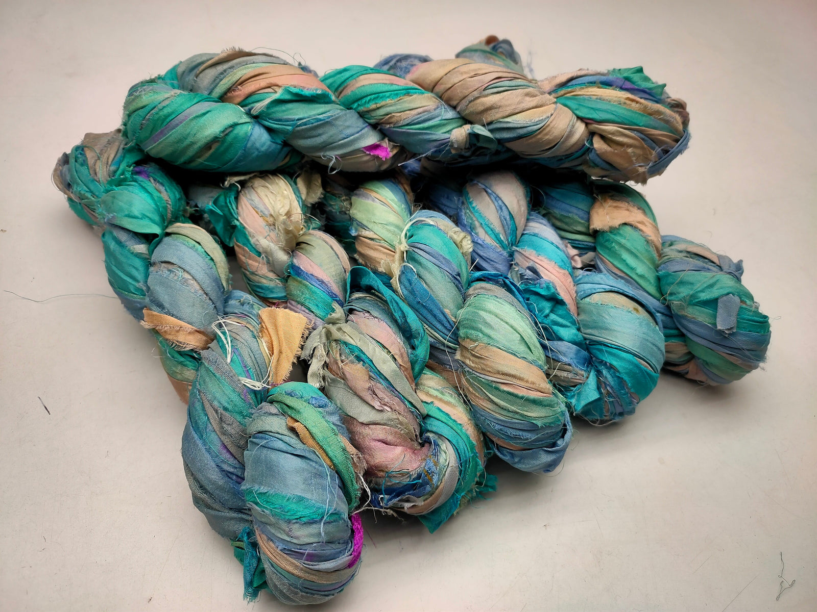 Recycled Sari silk Ribbon is the by-product of colorful saris that women wear in India. It is the loose ends of saris collected from industrial mills in India that is torn in stripes and sewn end to end to make beautiful and colorful ribbons. 