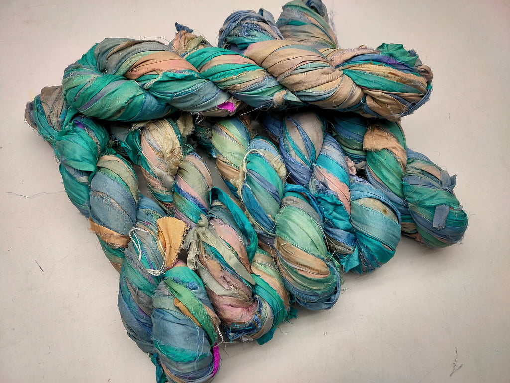 Recycled Sari silk Ribbon is the by-product of colorful saris that women wear in India. It is the loose ends of saris collected from industrial mills in India that is torn in stripes and sewn end to end to make beautiful and colorful ribbons. 