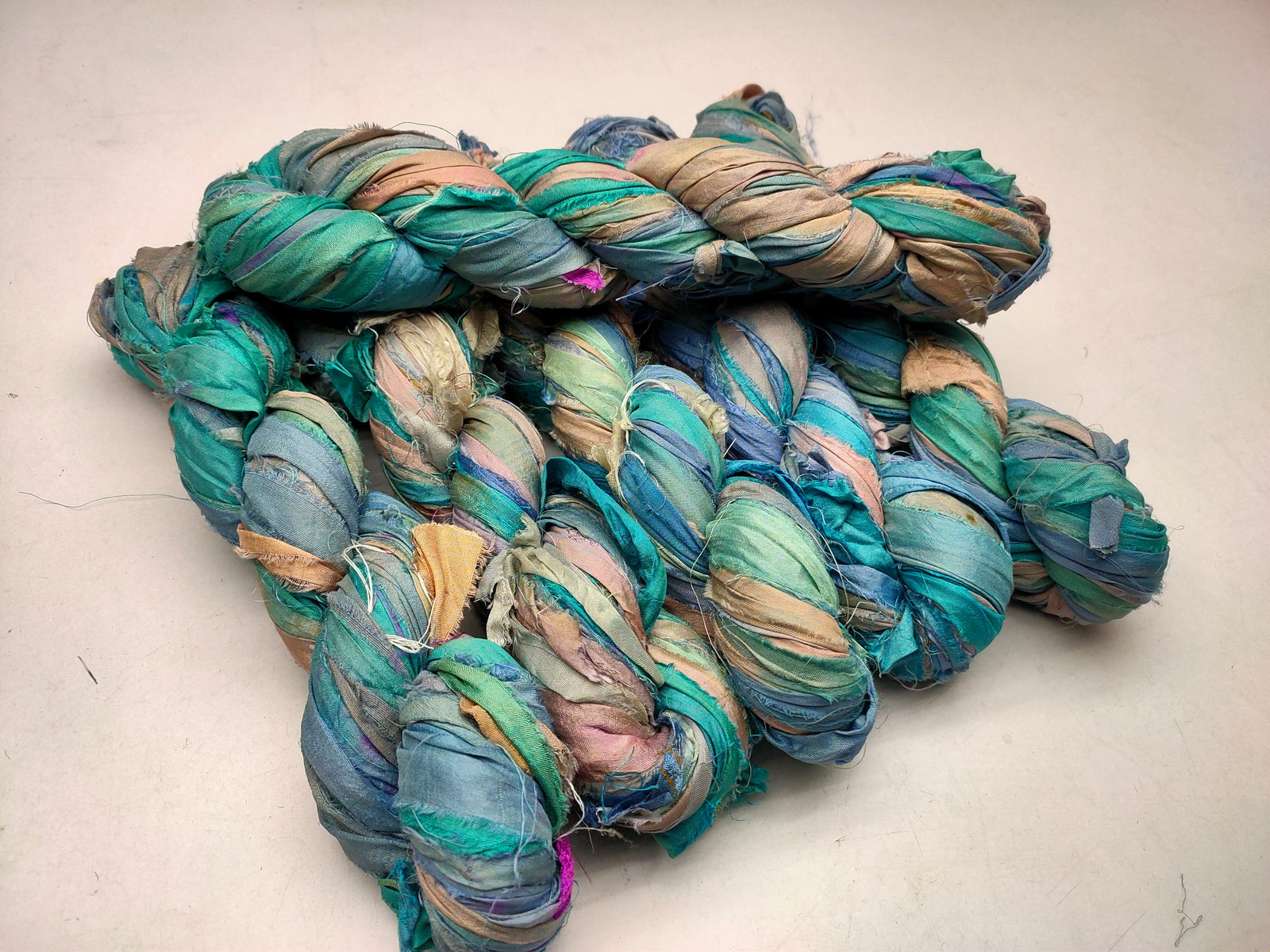 Recycled Sari silk Ribbon is the by-product of colorful saris that women wear in India. It is the loose ends of saris collected from industrial mills in India that is torn in stripes and sewn end to end to make beautiful and colorful ribbons. 