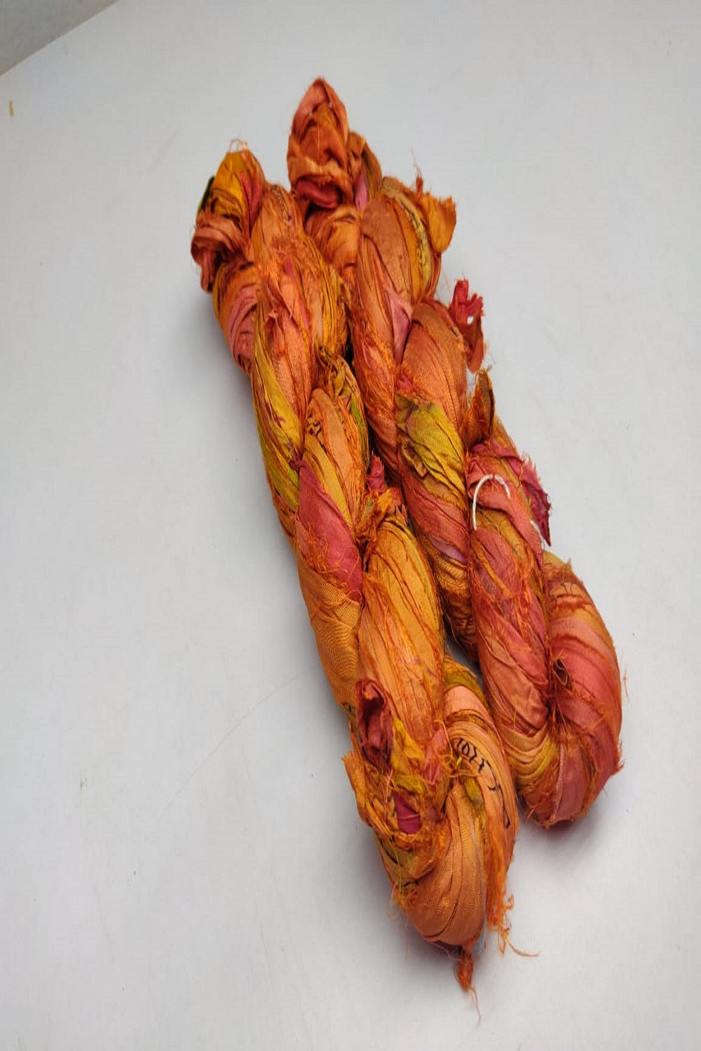 Recycled Sari silk Ribbon is the by-product of colorful saris that women wear in India. It is the loose ends of saris collected from industrial mills in India that is torn in stripes and sewn end to end to make beautiful and colorful ribbons. The vibrant colors and unique texture of these silk fabric,