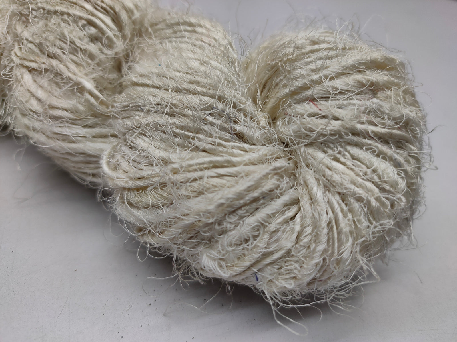Recycled Sari Silk Yarn Prime White - SilkRouteIndia - Recycled Sari Silk Yarn Prime is available in multitude of colors, and being premium, you get extra length of yarn in the same weight. We fabricate Recycled Silk Yarn from the bi-product of sari and silk production units.