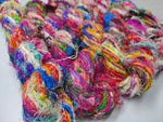 Recycled Sari Silk Yarn - Carded - SilkRouteIndia -Recycled Sari Silk Yarn - Carded is available in multitude of colors, and being premium, you get extra length of yarn in the same weight. We fabricate Recycle Sari Silk Yarn from the bi-product of sari and silk production units. The Yarn, available with us, is hand spun into bright hanks which is suitable for number of Handicrafts applications.