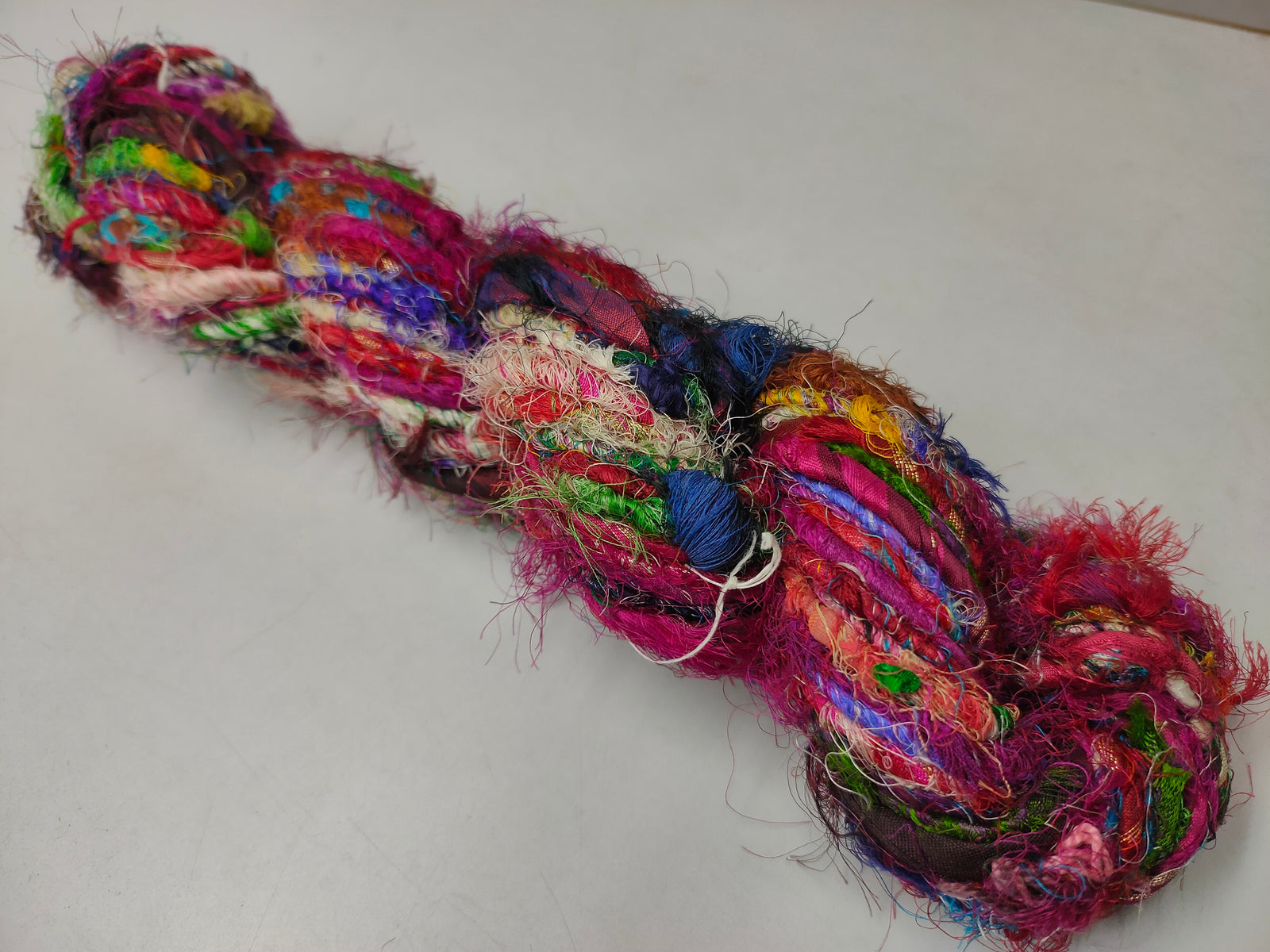 Recycled Sari Silk Yarn - Carded - SilkRouteIndia - Recycled Sari Silk Yarn - Carded is available in multitude of colors, and being premium, you get extra length of yarn in the same weight. We fabricate Recycle Sari Silk Yarn from the bi-product of sari and silk production units. The Yarn, available with us, is hand spun into bright hanks which is suitable for number of Handicrafts applications.