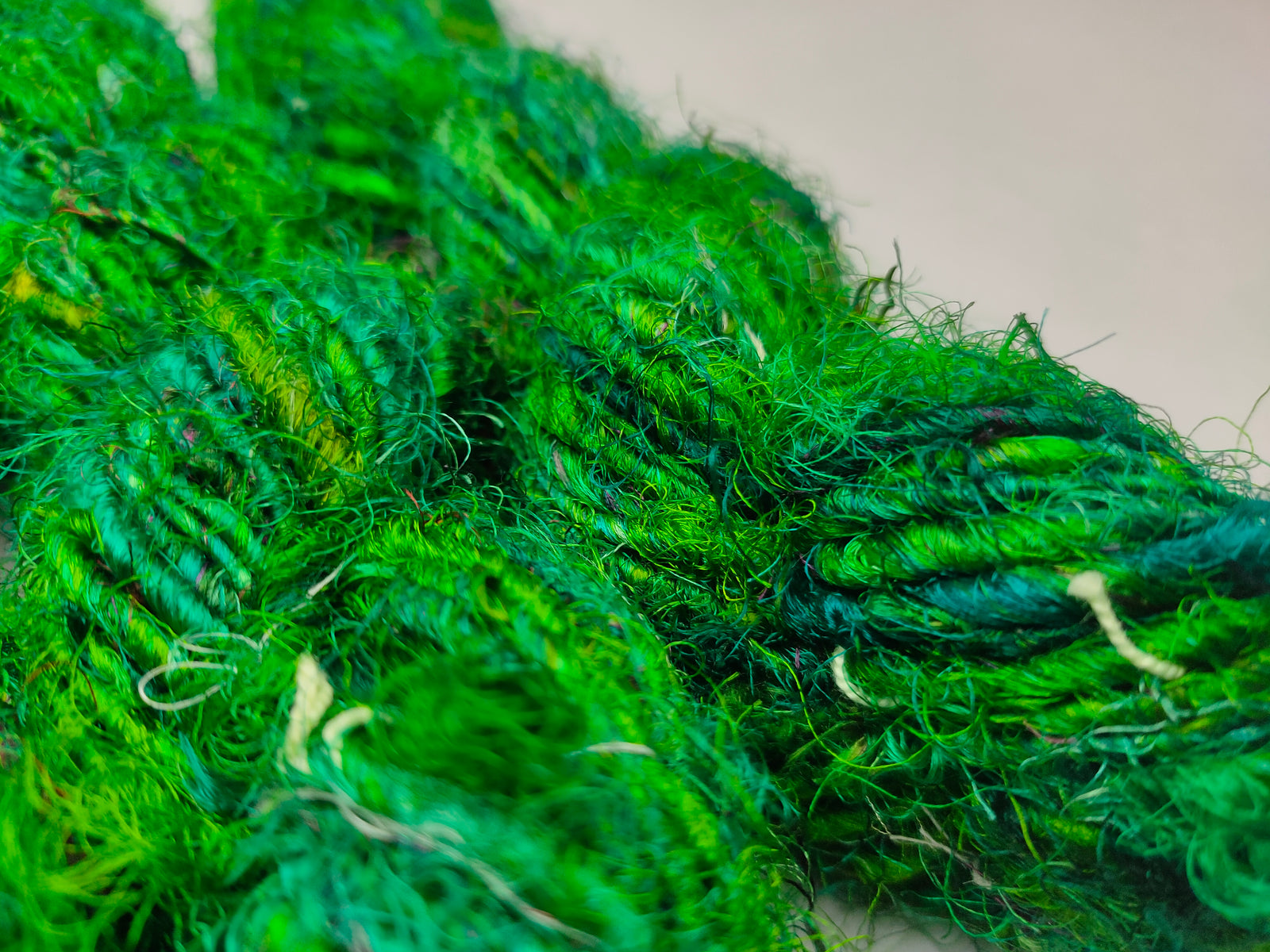 Recycled Sari Silk Yarn Green - SilkRouteIndia - Recycled Sari Silk Yarn is available in multitude of colors, and being premium, you get extra length of yarn in the same weight. We fabricate Recycle Sari Silk Yarn from the bi-product of sari and silk production units. The Yarn, available with us, is hand spun into bright hanks 