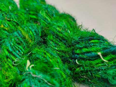 Recycled Sari Silk Yarn Green - SilkRouteIndia - Recycled Sari Silk Yarn is available in multitude of colors, and being premium, you get extra length of yarn in the same weight. We fabricate Recycle Sari Silk Yarn from the bi-product of sari and silk production units. The Yarn, available with us, is hand spun into bright hanks 