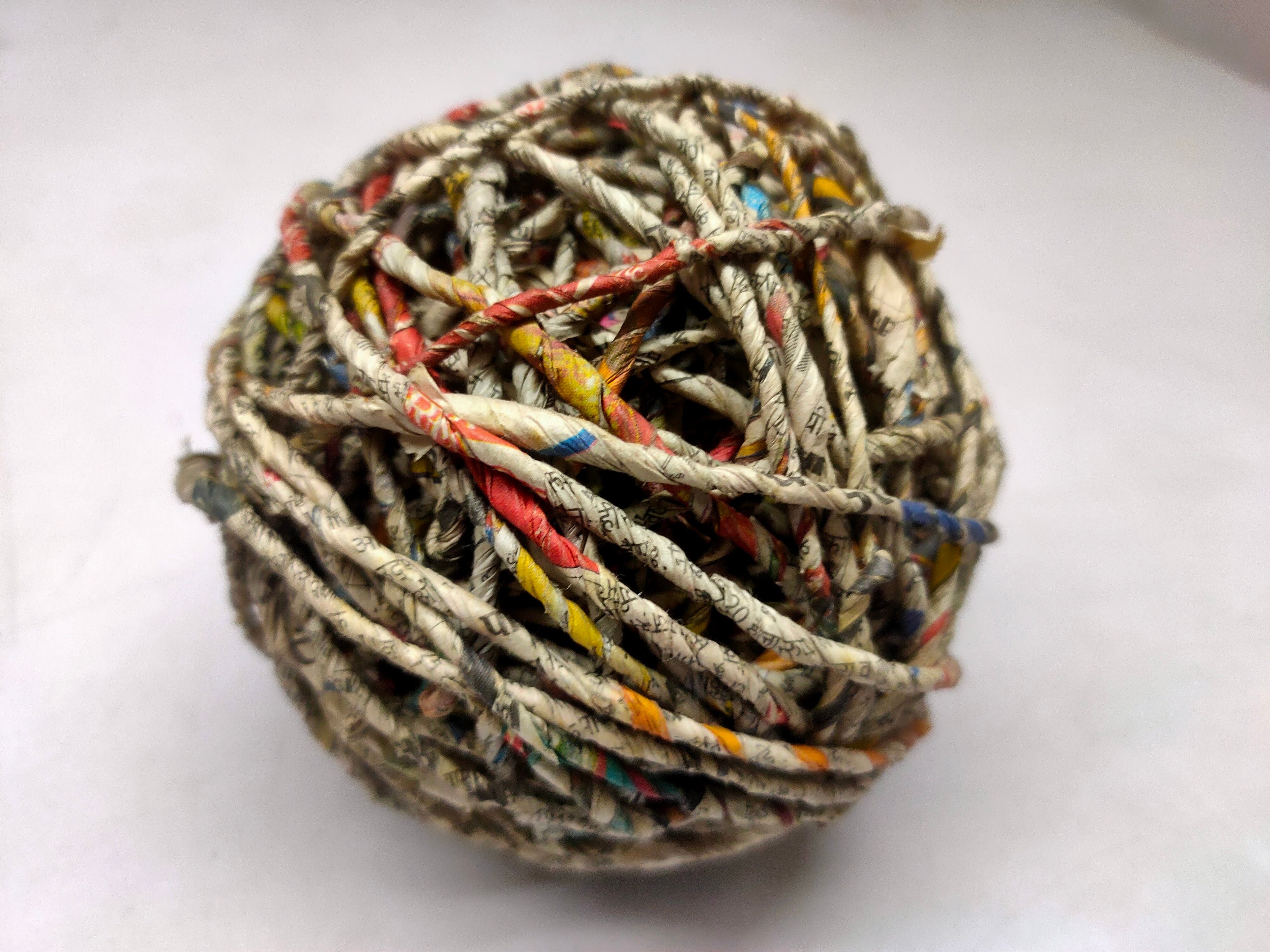 Indian Newspaper Yarn - SilkRouteIndia - Its wonderful idea to up-cycle paper that we use everyday, turning it into a different product to give it a new life. Handspun newspaper yarn is made by the women residing countryside, using old newspaper and the drop spindle. You can use the yarn to make several weaving, kn