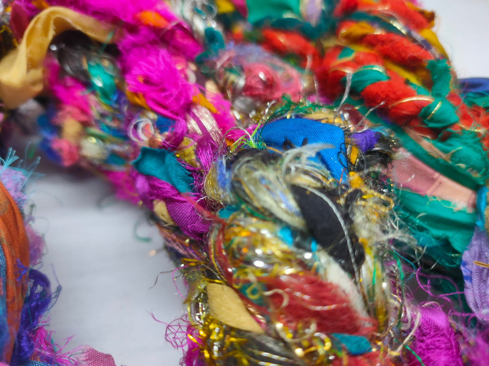 Recycled Yarn - Braided Lurex - SilkRouteIndia- Recycled Yarn - Braided lurex is available in multitude of colors. We fabricate Recycled Sari Yarn from the bi-product of sari and silk production units. The Yarn, available with us, is hand spun into bright hanks which is suitable for number of Handicrafts applications.