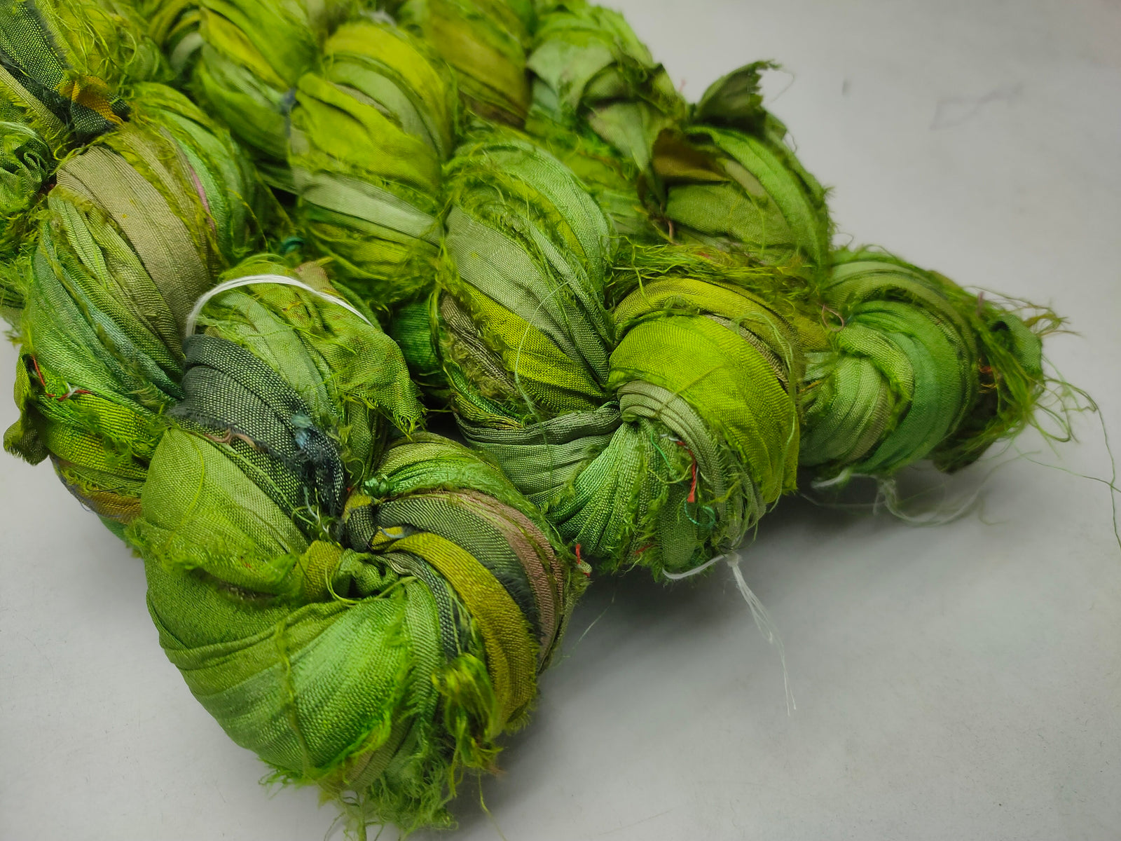 Recycled Sari Silk Ribbon - Green Petal - SilkRouteIndia Recycled Sari SilK yarn, Recycled Sari Silk Ribbon, Recycled Sari yarn, Recycled Silk Ribbon,upcycled ribbon, upcycled yarn, Himalaya Silk Yarn, Recycle Sari silk,	Recycle Silk,	Yarn for Knitting,	Knitting Yarn,	Crochet Yarn,	handcrafted yarn,	recycle sari yarn,	Sari Silk Yarn, reused ribbon, recycled ribbon