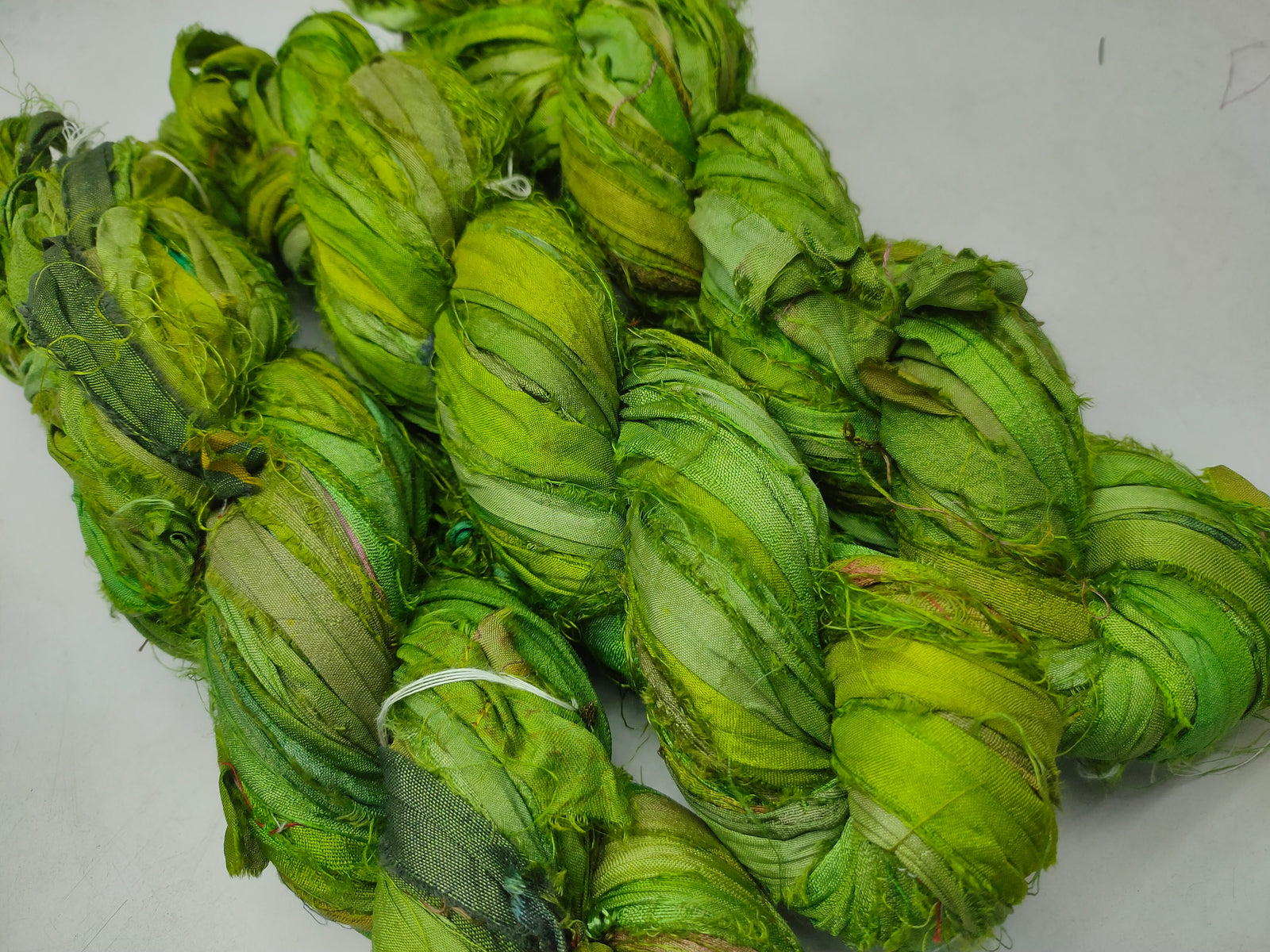 Recycled Sari Silk Ribbon - Green Petal - SilkRouteIndia Recycled Sari SilK yarn, Recycled Sari Silk Ribbon, Recycled Sari yarn, Recycled Silk Ribbon,upcycled ribbon, upcycled yarn, Himalaya Silk Yarn, Recycle Sari silk,	Recycle Silk,	Yarn for Knitting,	Knitting Yarn,	Crochet Yarn,	handcrafted yarn,	recycle sari yarn,	Sari Silk Yarn, reused ribbon, recycled ribbon