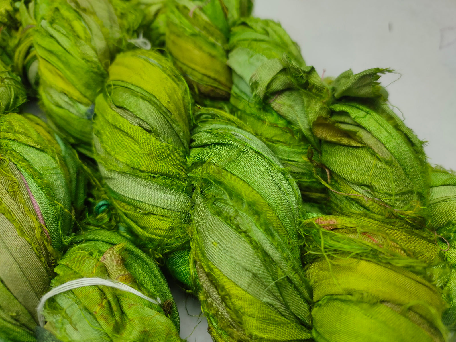 Recycled Sari Silk Ribbon - Green Petal - SilkRouteIndia Recycled Sari SilK yarn, Recycled Sari Silk Ribbon, Recycled Sari yarn, Recycled Silk Ribbon,upcycled ribbon, upcycled yarn, Himalaya Silk Yarn, Recycle Sari silk,	Recycle Silk,	Yarn for Knitting,	Knitting Yarn,	Crochet Yarn,	handcrafted yarn,	recycle sari yarn,	Sari Silk Yarn, reused ribbon, recycled ribbon