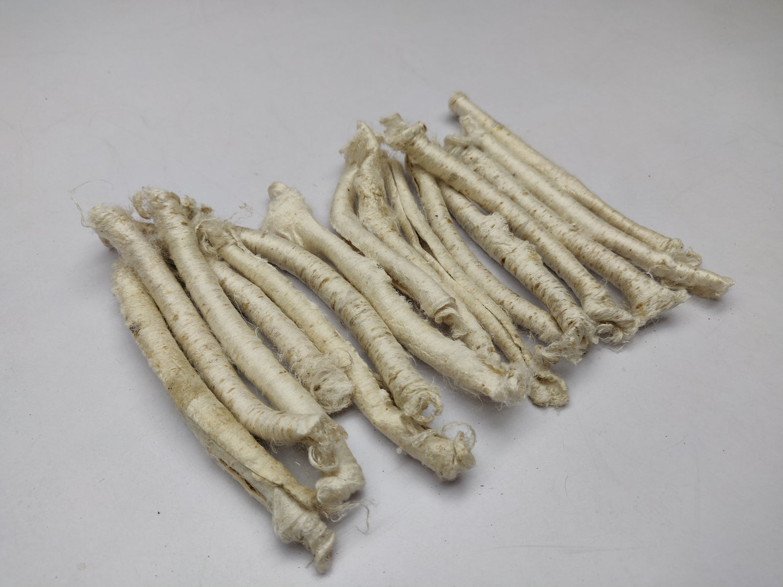 Mulberry Silk Carrier Rods - SilkRouteIndia - Carrier Rods are a waste product in the silk spinning industry. Perfect for surface texture during felting and can be dyed as per need. If you sprinkle it with water and iron them flat then you can create a sort of silk paper. Original pieces will be criss cross or slightly twisted. Use them in your felting, create unique and interesting jewelry, textural stitching and silk fusion. 